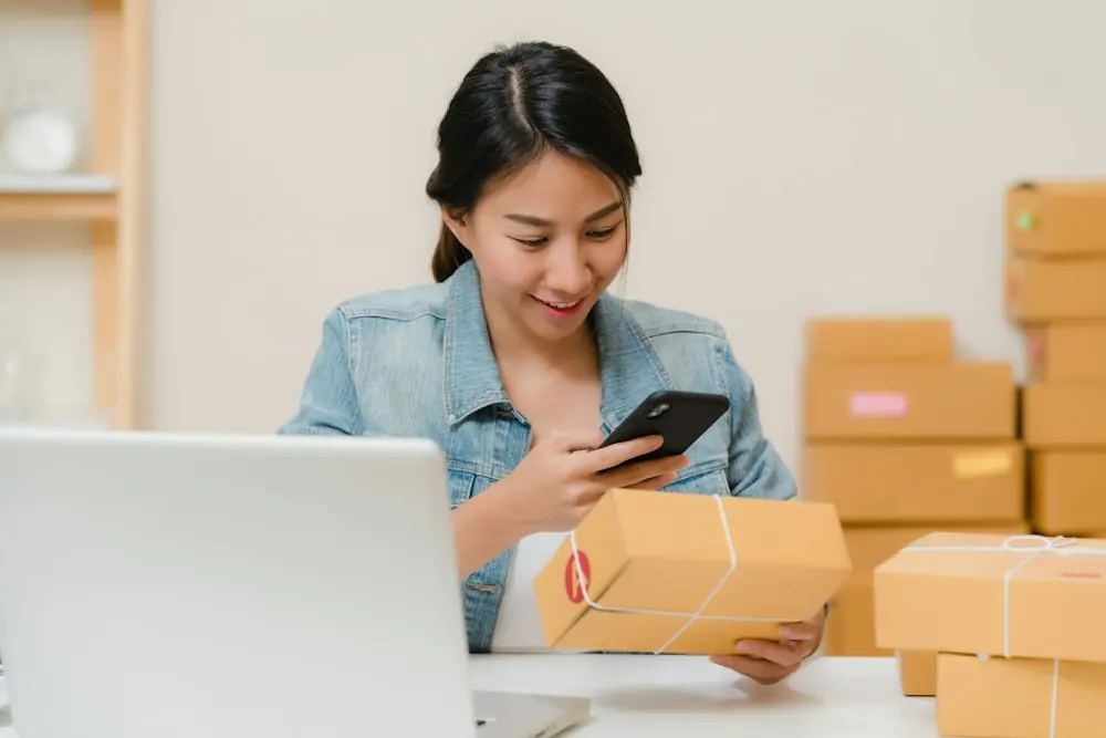 Woman checking a parcel with her phone